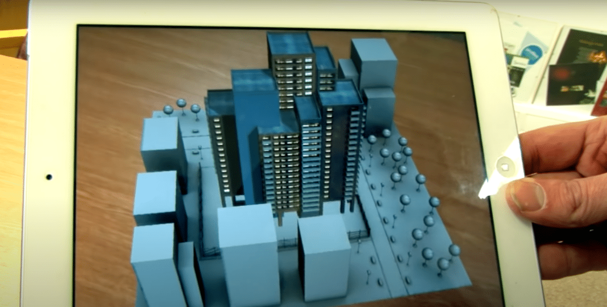 Photo of an augmented reality rendering of a planned commercial real estate building on an iPad.